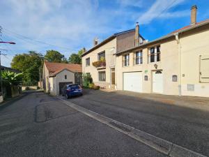 a blue car parked on the side of a street at Le Cottage du Château in Faulx