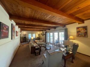 a living room with couches and chairs and a wooden ceiling at Berkshire Inn in Groveland