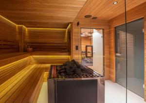 a sauna with a stove in the middle at Hotel 1231 in Toruń