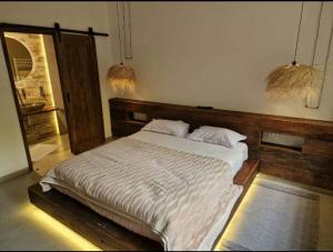 a bedroom with a large bed in a room at Dar Khedija in El Kheriba