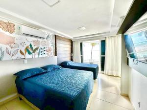 a bedroom with two blue beds in a room at FHF Blue Suites in João Pessoa