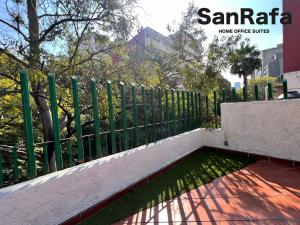 a green fence next to a pool of water at SanRafa Polanco I in Mexico City