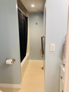 a bathroom with a door open to a bathroom with a shower at Finished 2 BR Apartment in an Upscale Area of Ajax in Ajax