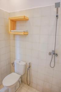a bathroom with a toilet and a shower at SurfAppart Morocco in Tamraght Ouzdar