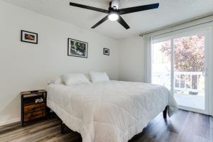 a white bedroom with a bed and a ceiling fan at Retreat near UO, Autzen Stadium, Amazon Park (# 1) in Eugene