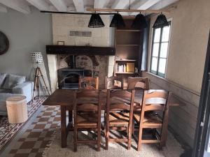 a dining room with a table and chairs and a fireplace at D'une rive à l'autre in Francueil +32 photos