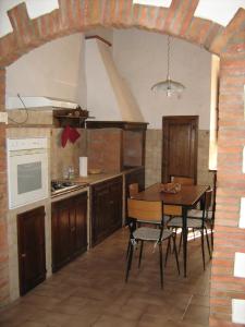 a kitchen with a wooden table and a dining room at Casa Vacanze Sasso Pisano in Sasso Pisano