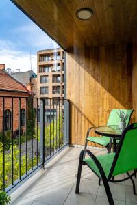 a patio with a table and chairs on a balcony at Apartamenty Prestige Browar Lubicz Stare Miasto in Krakow