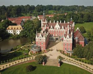 an aerial view of a large pink building with a bridge at Ferienwohnung in 03159 Döbern 