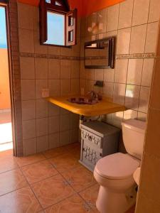 a bathroom with a toilet and a sink at Casa Jardin in Lo de Marcos