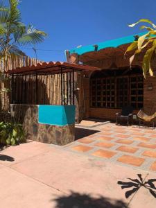 a house with a fence and a brick patio at Casa Jardin in Lo de Marcos