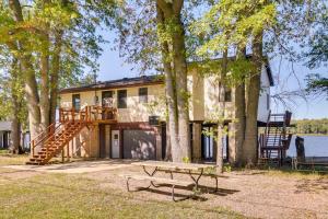 a house with a deck and a picnic table at Riverfront Fulton Vacation Rental with Deck and Grill! in Fulton