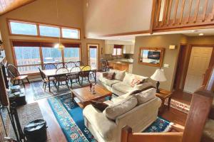 a living room with a couch and a table at Large 5 bedroom Bretton Woods Townhome 1 gig WiFi in Bretton Woods