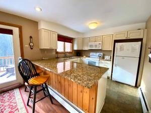 a kitchen with a counter and a refrigerator at Large 5 bedroom Bretton Woods Townhome 1 gig WiFi in Bretton Woods