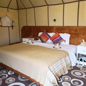 a bedroom with a large bed in a tent at Four Season Camp in Merzouga