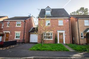 a red brick house with a white garage at Airport LPL - Driveway Parking - Garden in Widnes