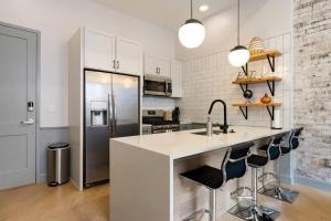 a kitchen with a sink and a refrigerator at Gorgeous Condo in the Heart of DT Birmingham! in Birmingham