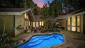 a swimming pool in the backyard of a house at Smoky Speakeasy 2 Cabins 2 Hot Tubs and Private Pool in Gatlinburg