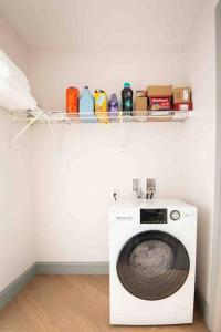 a laundry room with a washing machine in a room at Lovely Condo in Downtown Birmingham in Birmingham