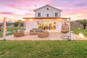 una terraza en el patio trasero con un columpio y una casa en CASAL DEL SOLE, en Montefelcino