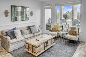 a living room with a couch and a coffee table at Beach and Gulf Views from the Center of Seaside! condo in Santa Rosa Beach