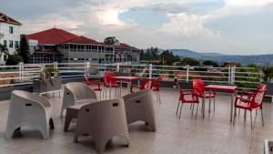 a group of tables and chairs on a balcony at Dove Hotel Kigali in Kigali