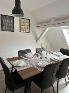 a dining room table with chairs and a wooden tableablish at PrimeBnb Bad Salzungen in Bad Salzungen