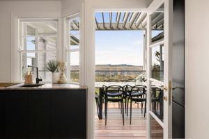 a kitchen and dining room with a table and chairs at Blue Mountains Bliss in Leura