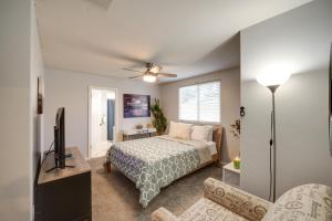 a bedroom with a bed and a tv and a couch at Pet-Friendly Family House with Pool and Backyard in Bakersfield