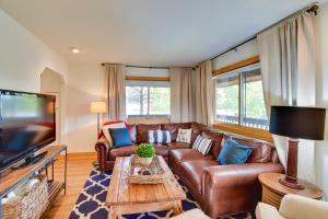 a living room with a leather couch and a tv at Family-Friendly Steamboat Springs Home with Hot Tub! in Steamboat Springs