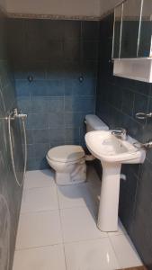 a bathroom with a toilet and a sink at Posada the secret in Colonia del Sacramento