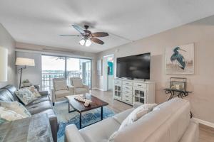 a living room with a couch and a tv at Pet-friendly 2-bed Condo With Amazing Waterfront Views in Clearwater Beach