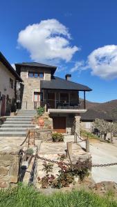 a large house with stairs and a building at CASA RURAL PAJARICA en Sanabria in San Ciprián