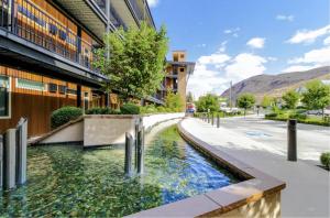 a river in a street next to a building at Chelan Resort Suites by DC in Chelan