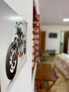 a picture of a motorcycle hanging on a wall at Pousada São Pedro in Flecheiras