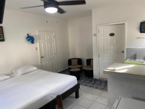 a bedroom with a bed and a bathroom with a sink at Caribo Cozumel in Cozumel