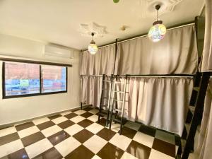 a room with curtains and a checkered floor at Friends Oasis in Aqaba