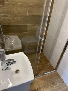 een badkamer met een witte wastafel en een douche bij Mazowiecka 29 Apartment B self check-in in Bydgoszcz