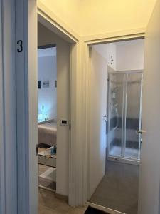a bathroom with a walk in shower and a glass door at B&B San Vitale in Bologna