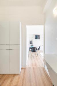 a white room with a table and a chair at Home Sweet Home - Design & Zen in Luxembourg +19 photos