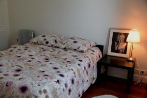 a bedroom with a bed and a picture on a table at Eiffel Tower Oasis 30m from Eiffel Tower in Paris