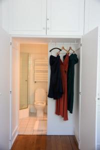 a bathroom with a toilet and a closet at Eiffel Tower Oasis in Paris