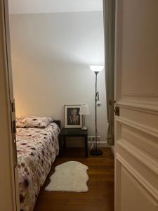 a bedroom with a bed and a table with a lamp at Eiffel Tower Oasis 30m from Eiffel Tower in Paris