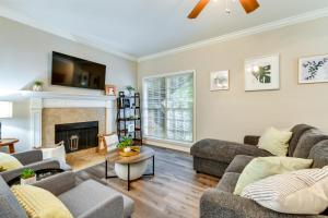 a living room with couches and a fireplace at Baton Rouge Condo with Community Pool 6 Mi to LSU! in Baton Rouge