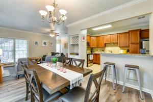a dining room and kitchen with a table and chairs at Baton Rouge Condo with Community Pool 6 Mi to LSU! in Baton Rouge