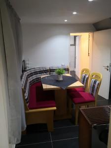 a room with a table and chairs and a bed at Haus am Fluss in Urft
