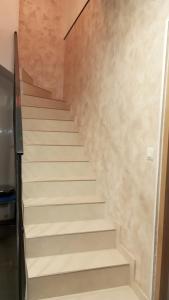 a stair case in a house with white stairs at Maison au calme in Livry-Gargan
