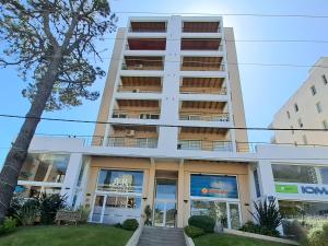 an apartment building with balconies on it at Luminoso Departamento in Pinamar