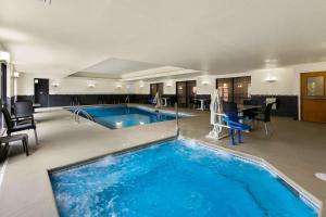 a large swimming pool in a hotel room at Comfort Suites in Commerce