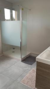 a bathroom with a glass shower and a sink at Maison au calme in Livry-Gargan